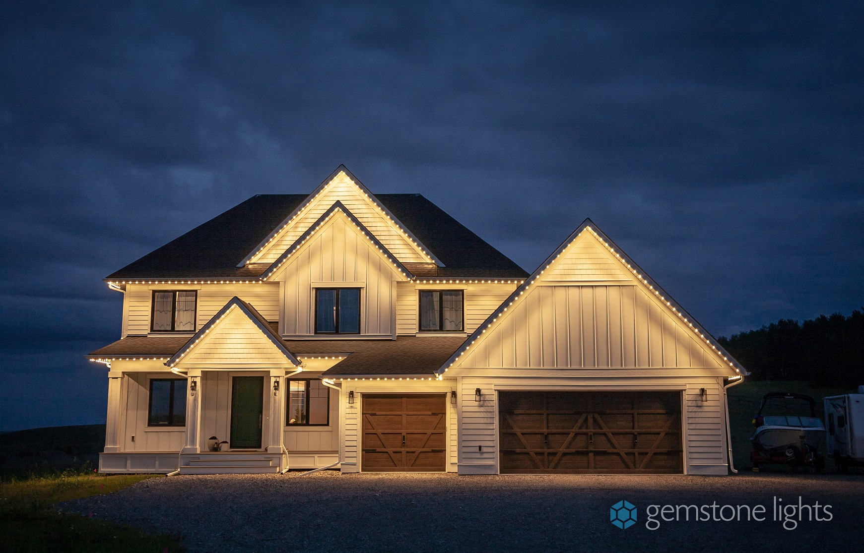 Home with permanent LED roofline lighting glowing at night